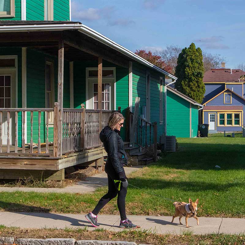 Woman walking dog in Five Points, Dayton OH